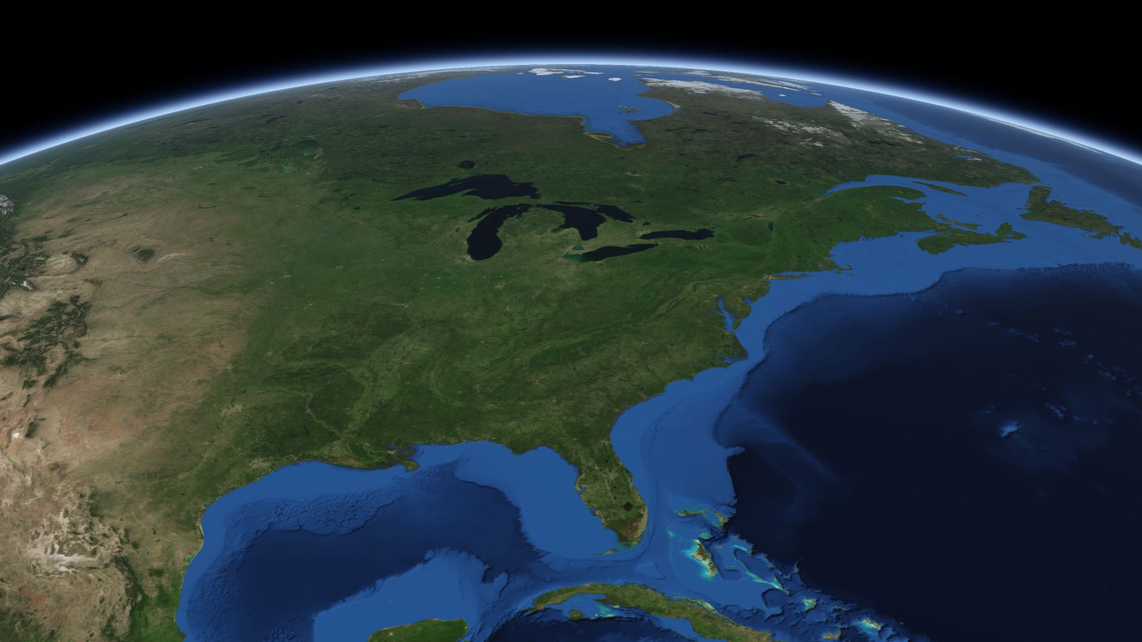 The curve of the Earth seen from orbit, with Columbus ringed in amber near the middle of the picture.